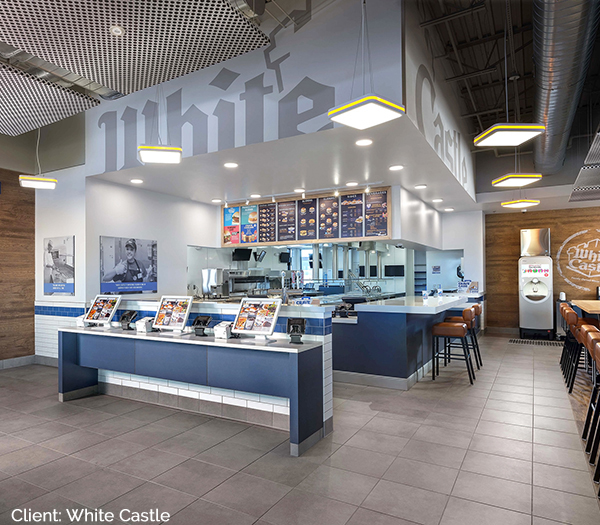 Interior image of architecturally remodeled white castle restaurant showing register and digital self ordering stations.